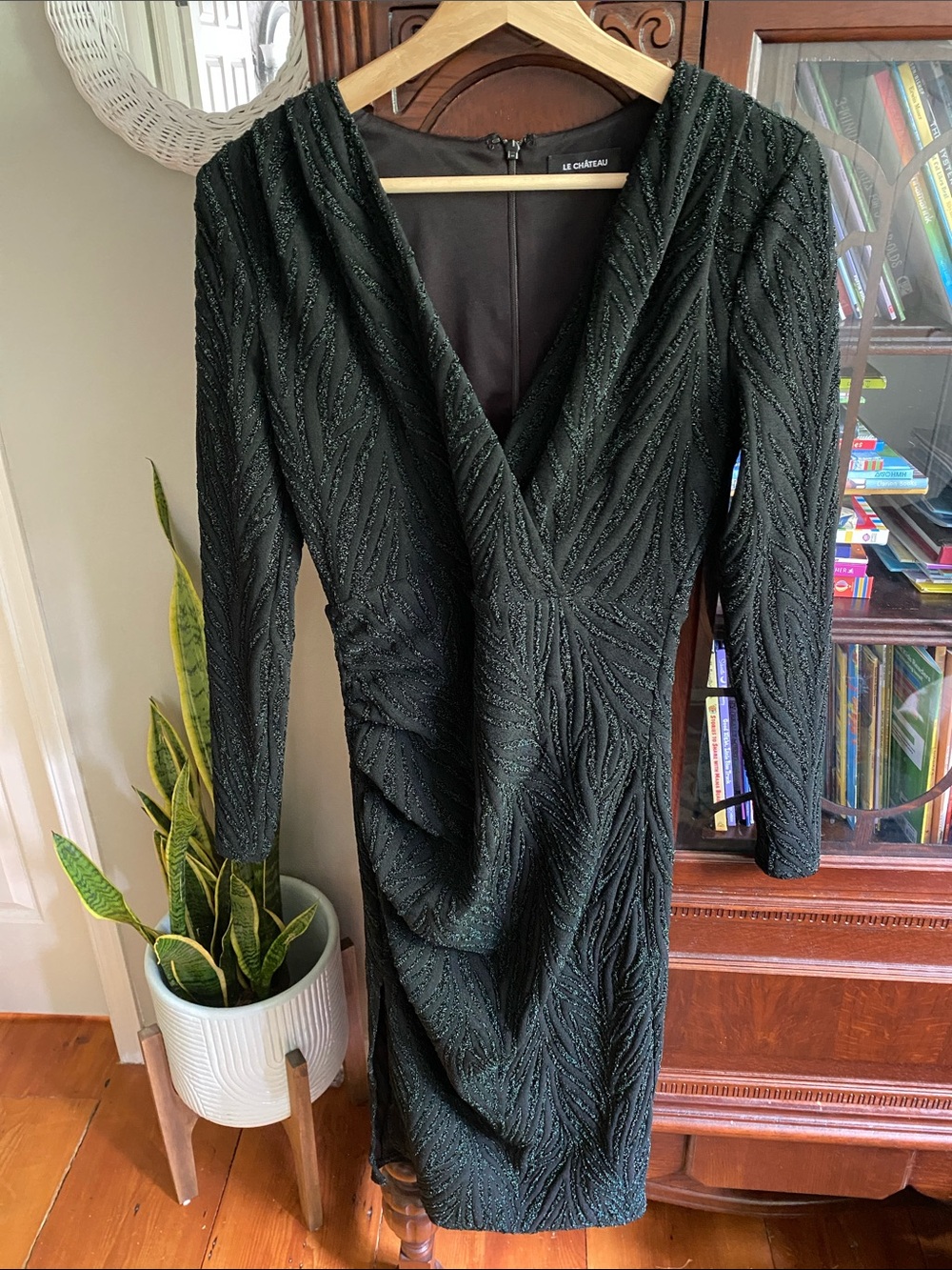 Beautiful dark green V-neck dress with metallic detailing.
